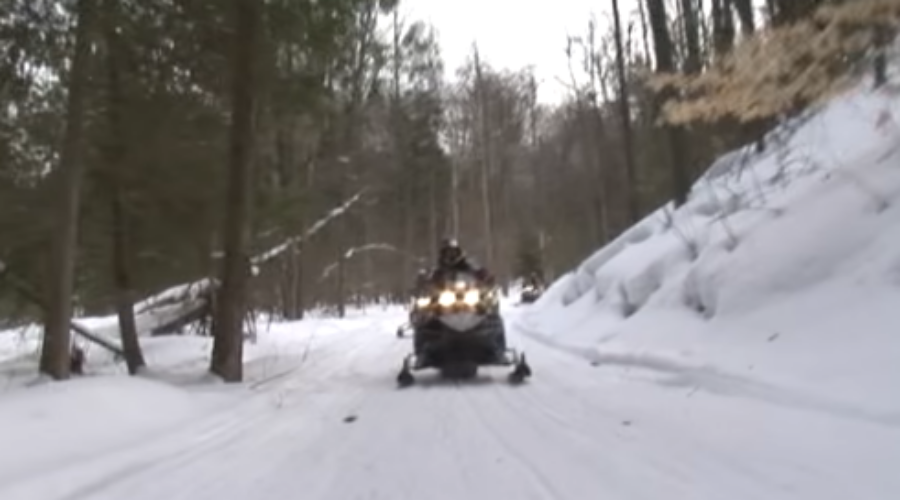 Snowmobiles to gain access to snow covered roads and shoulders